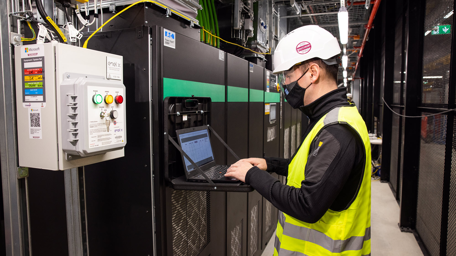 A worker tests a grid-interactive UPS at a datacenter in Dublin.